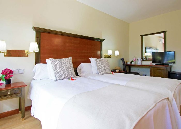 Habitación doble con camas separadas y con televisión en  hotel sostenible en Lanzarote